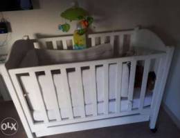 White crib with mattress and sheets