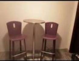 two bar chairs with table