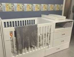 Baby crib with changing table