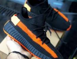 black and orange Yeezy sneakers multiple o...